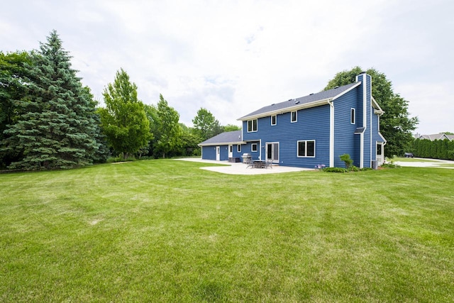 14240 Radiant Ct, Brookfield, WI 53005 - back of property featuring a chimney, a patio area, and a lawn