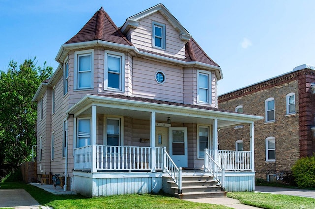 2110 54th St, Kenosha, WI 53140 - victorian home featuring a porch