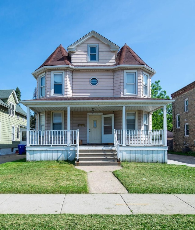 2110 54th St, Kenosha, WI 53140 - victorian house with a porch and a front lawn