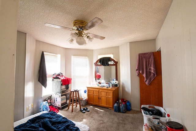 2110 54th St, Kenosha, WI 53140 - bedroom with a textured ceiling, carpet flooring, a ceiling fan, and wood walls
