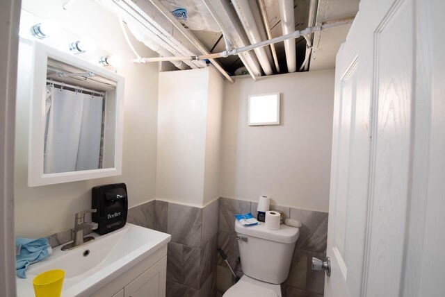 2110 54th St, Kenosha, WI 53140 - full bath featuring tile walls, vanity, and wainscoting