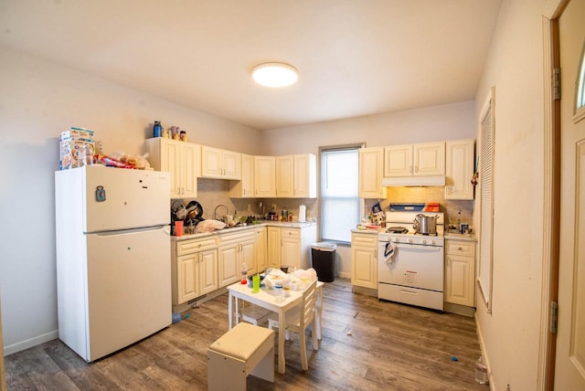 2110 54th St, Kenosha, WI 53140 - kitchen with white appliances, under cabinet range hood, decorative backsplash, light countertops, and dark wood-style flooring