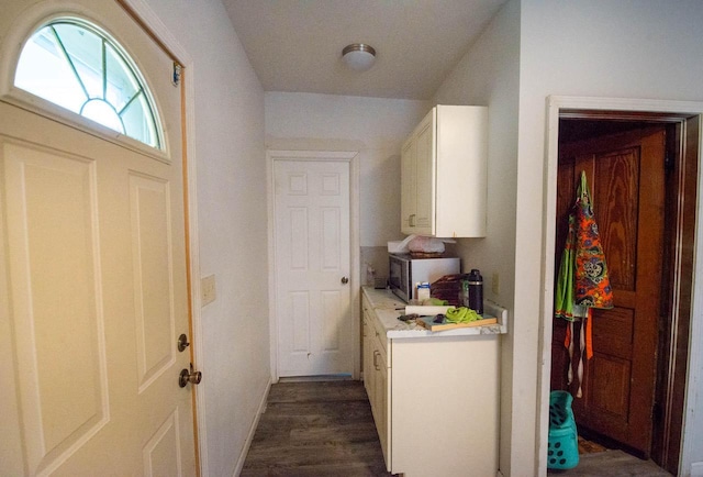 2110 54th St, Kenosha, WI 53140 - laundry area with dark wood-style floors and baseboards
