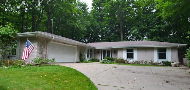 3333 N 12th St, Wausau, WI 54403 - ranch-style home featuring brick siding, an attached garage, concrete driveway, and a front lawn