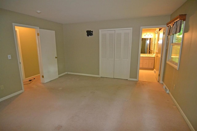 3333 N 12th St, Wausau, WI 54403 - unfurnished bedroom with a closet, connected bathroom, and light carpet