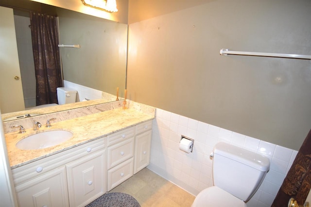 3333 N 12th St, Wausau, WI 54403 - bathroom featuring vanity, tile walls, wainscoting, curtained shower, and tile patterned flooring
