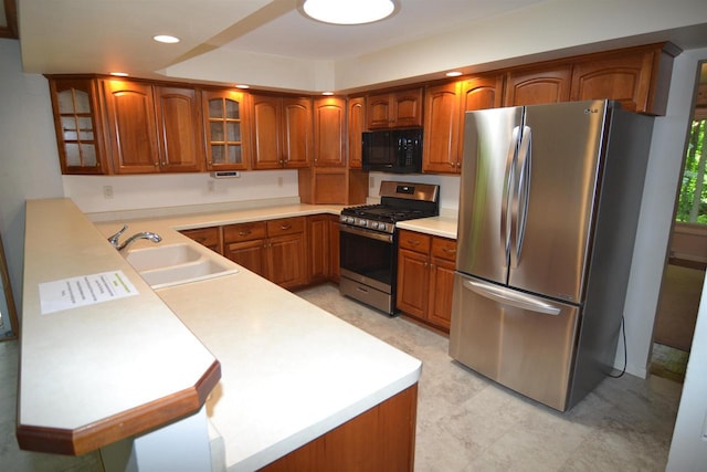 3333 N 12th St, Wausau, WI 54403 - kitchen featuring appliances with stainless steel finishes, brown cabinetry, glass insert cabinets, light countertops, and recessed lighting
