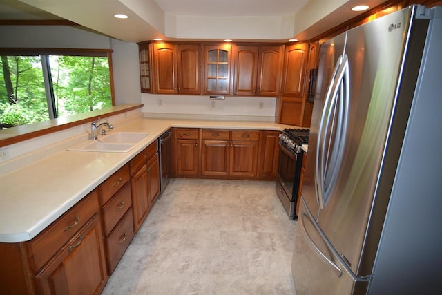3333 N 12th St, Wausau, WI 54403 - kitchen featuring stainless steel appliances, brown cabinets, recessed lighting, glass insert cabinets, and light countertops