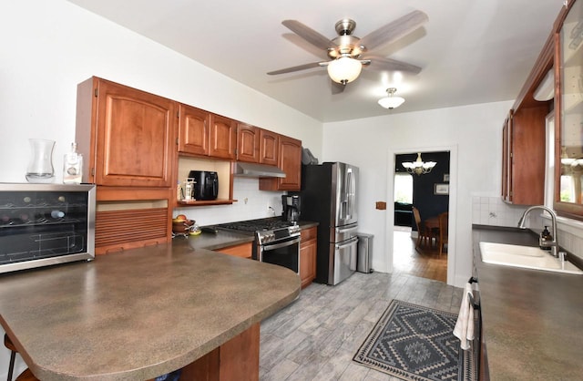 1032 Russet St, Racine, WI 53405 - kitchen featuring appliances with stainless steel finishes, a peninsula, tasteful backsplash, dark countertops, and ceiling fan