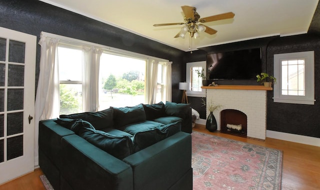 1032 Russet St, Racine, WI 53405 - living room featuring wood finished floors, a ceiling fan, and a brick fireplace