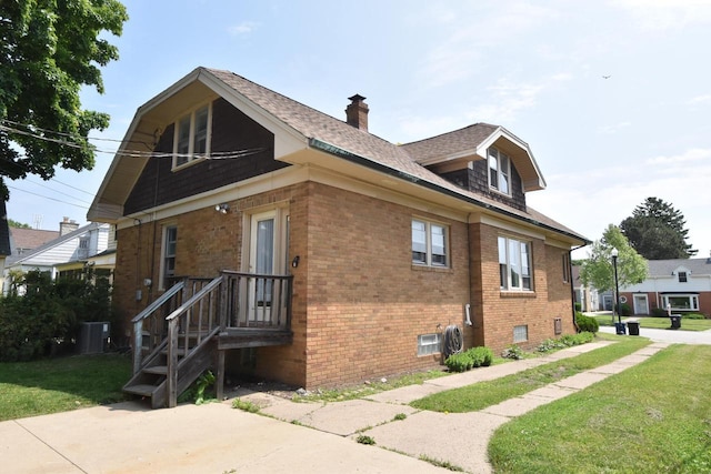 1032 Russet St, Racine, WI 53405 - view of side of home featuring brick siding, a chimney, a yard, and a shingled roof