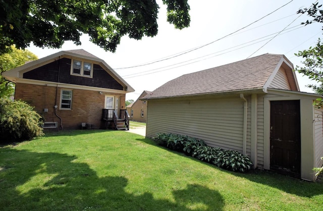 1032 Russet St, Racine, WI 53405 - back of house featuring a lawn, brick siding, and roof with shingles