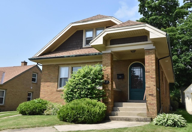 1032 Russet St, Racine, WI 53405 - view of front of home with brick siding, a shingled roof, and a front yard
