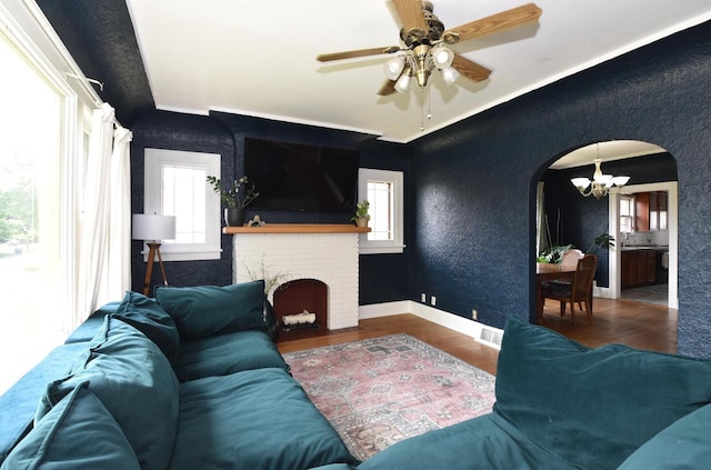 1032 Russet St, Racine, WI 53405 - living room featuring arched walkways, wood finished floors, a chandelier, ceiling fan, and a textured wall