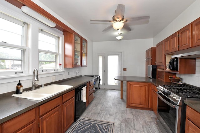 1032 Russet St, Racine, WI 53405 - kitchen featuring stainless steel gas range oven, black dishwasher, under cabinet range hood, and dark countertops