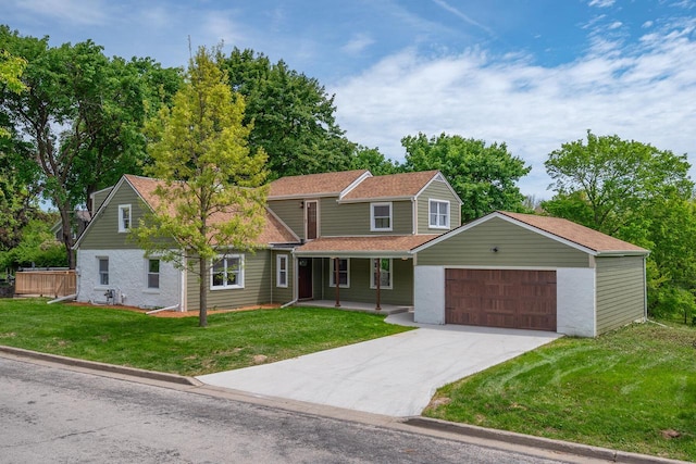 1120 N 124th St, Wauwatosa, WI 53226 - traditional-style house with a porch, a front lawn, a garage, and concrete driveway