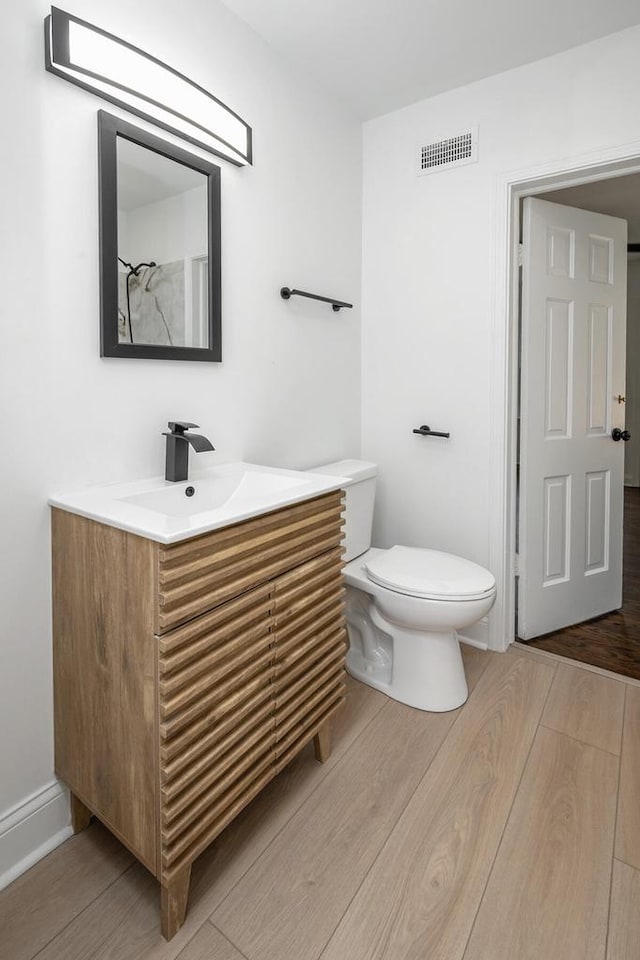 1120 N 124th St, Wauwatosa, WI 53226 - full bathroom featuring vanity and wood finished floors