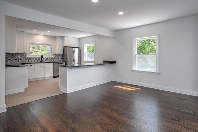 1120 N 124th St, Wauwatosa, WI 53226 - kitchen with appliances with stainless steel finishes, dark countertops, healthy amount of natural light, wood finished floors, and recessed lighting