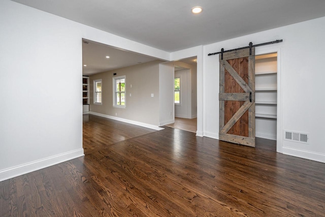 1120 N 124th St, Wauwatosa, WI 53226 - empty room featuring a barn door, wood finished floors, and recessed lighting