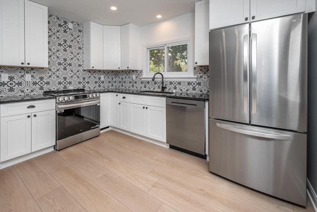 1120 N 124th St, Wauwatosa, WI 53226 - kitchen with appliances with stainless steel finishes, light wood-type flooring, decorative backsplash, white cabinetry, and recessed lighting