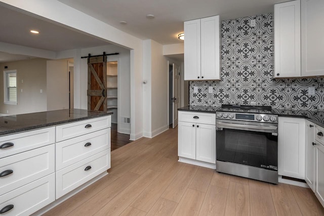1120 N 124th St, Wauwatosa, WI 53226 - kitchen with stainless steel electric range oven, a barn door, light wood-type flooring, white cabinetry, and backsplash