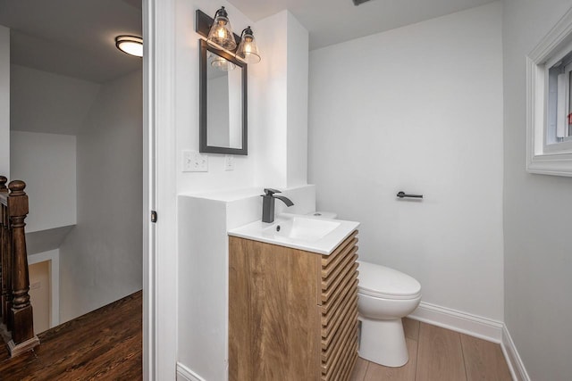 1120 N 124th St, Wauwatosa, WI 53226 - half bathroom featuring vanity and wood finished floors