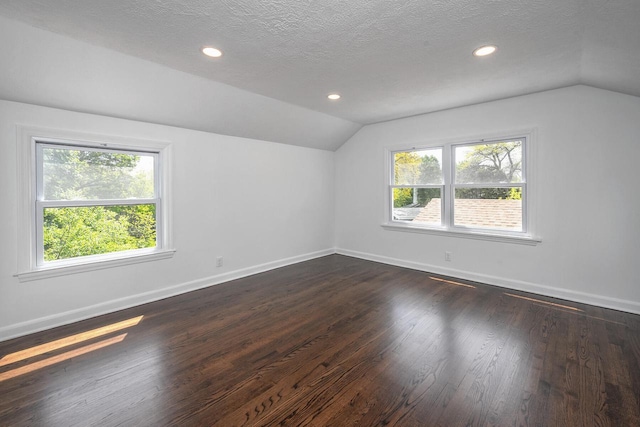 1120 N 124th St, Wauwatosa, WI 53226 - bonus room featuring vaulted ceiling, dark wood-style floors, healthy amount of natural light, a textured ceiling, and recessed lighting