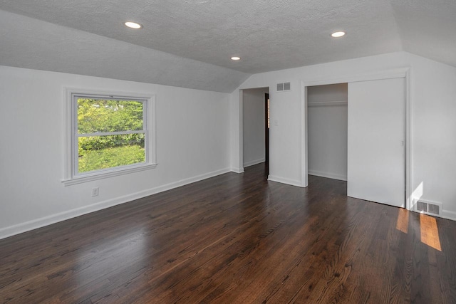 1120 N 124th St, Wauwatosa, WI 53226 - unfurnished bedroom with lofted ceiling, dark wood-style flooring, a textured ceiling, a closet, and recessed lighting