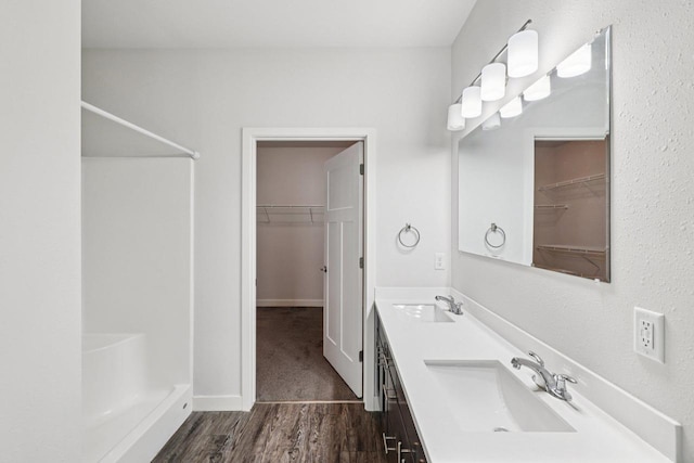 1601 N Windsor Ave Unit 106, Cottage Grove, WI 53527 - bathroom featuring a shower, a spacious closet, and wood finished floors