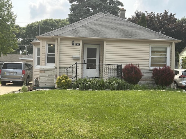 1961 S 94th St, West Allis, WI 53227 - bungalow-style home with a chimney, a shingled roof, a front yard, and stone siding