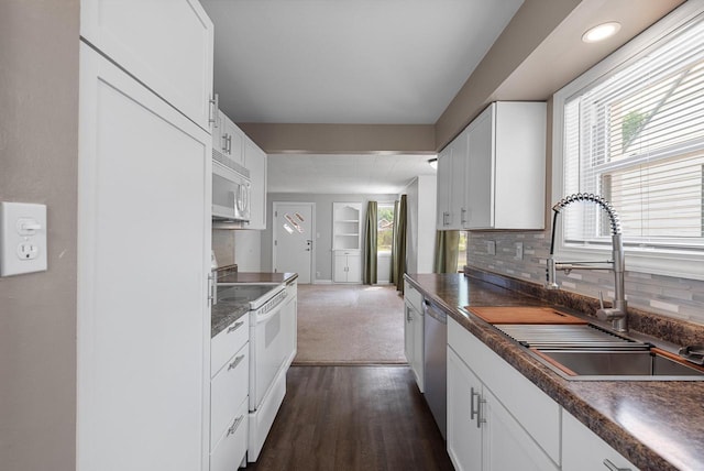 1961 S 94th St, West Allis, WI 53227 - kitchen with white appliances, dark countertops, white cabinets, and dark wood finished floors