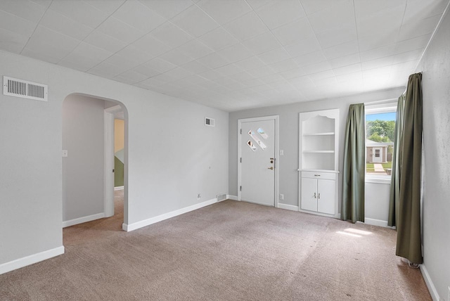 1961 S 94th St, West Allis, WI 53227 - empty room featuring arched walkways and carpet flooring