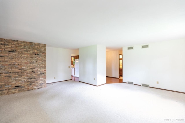 1813 Countryside Dr, Middleton, WI 53562 - carpeted empty room featuring brick wall and baseboards