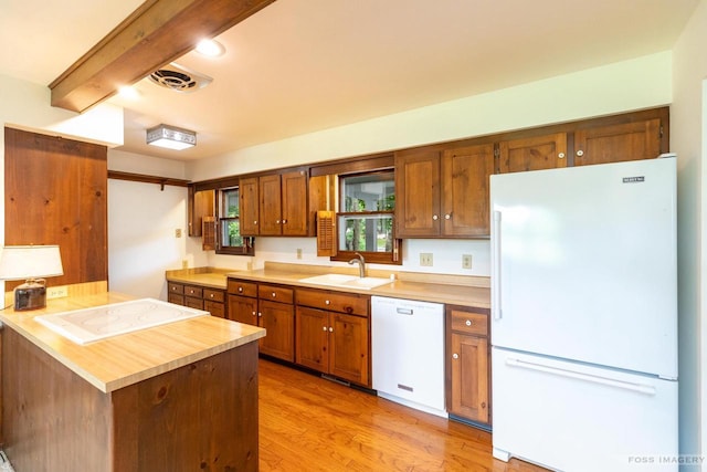 1813 Countryside Dr, Middleton, WI 53562 - kitchen featuring white appliances, brown cabinets, light countertops, light wood-style flooring, and beam ceiling