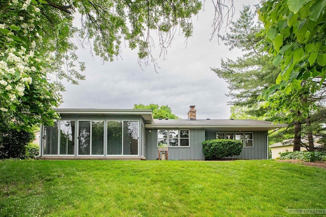 1813 Countryside Dr, Middleton, WI 53562 - back of property with a chimney, a yard, board and batten siding, and a sunroom