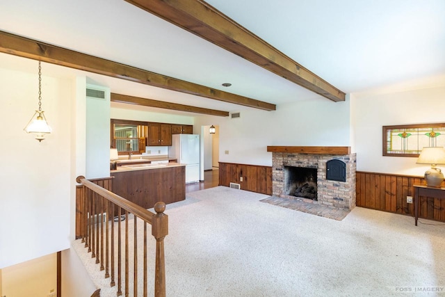 1813 Countryside Dr, Middleton, WI 53562 - living room featuring wainscoting, beamed ceiling, a brick fireplace, wooden walls, and carpet