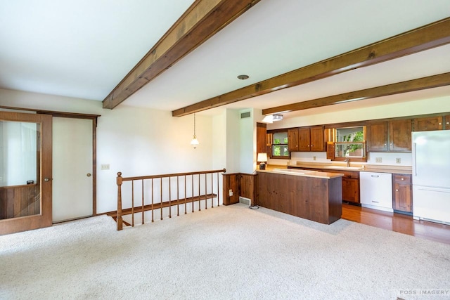 1813 Countryside Dr, Middleton, WI 53562 - kitchen featuring white appliances, carpet, beam ceiling, a peninsula, and light countertops
