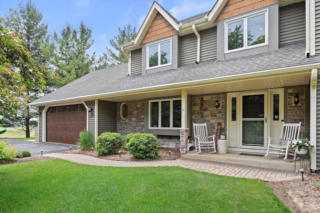 N80W32229 Northbrook Ct, Hartland, WI 53029 - view of front facade with a porch, a shingled roof, stone siding, an attached garage, and a front yard
