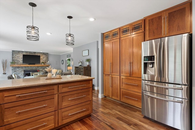 N80W32229 Northbrook Ct, Hartland, WI 53029 - kitchen with stainless steel fridge, brown cabinets, dark wood-type flooring, pendant lighting, and glass insert cabinets