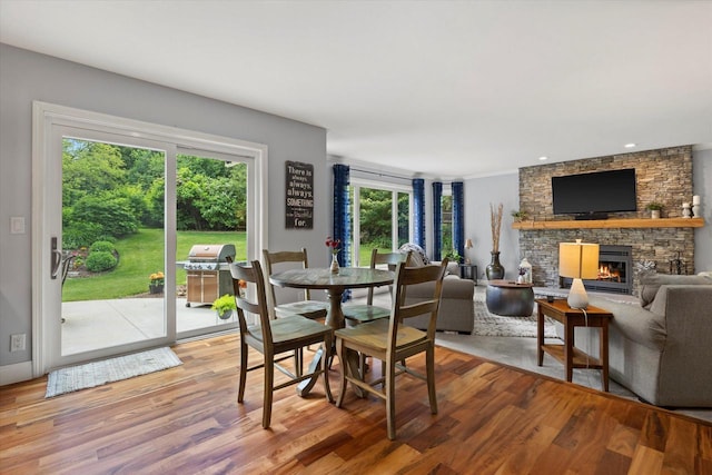 N80W32229 Northbrook Ct, Hartland, WI 53029 - dining space featuring light wood-style flooring, a stone fireplace, and recessed lighting