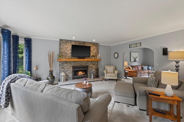 N80W32229 Northbrook Ct, Hartland, WI 53029 - living area featuring arched walkways, a stone fireplace, ornamental molding, recessed lighting, and carpet flooring