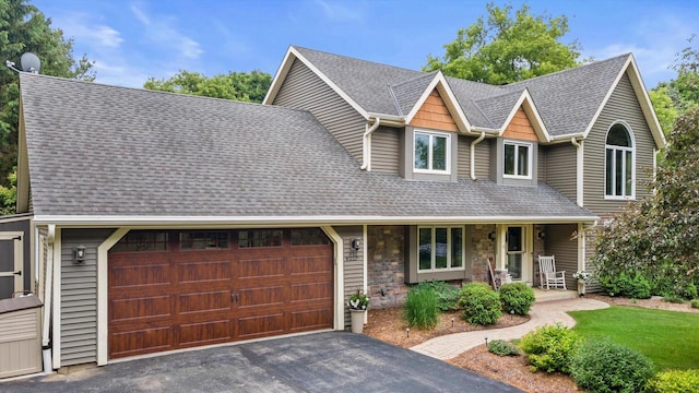 N80W32229 Northbrook Ct, Hartland, WI 53029 - view of front of property with covered porch, roof with shingles, and a garage