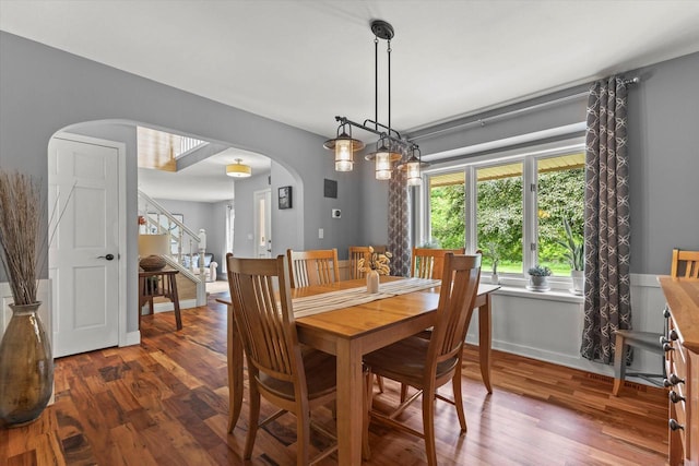 N80W32229 Northbrook Ct, Hartland, WI 53029 - dining space with arched walkways, wood finished floors, and stairway