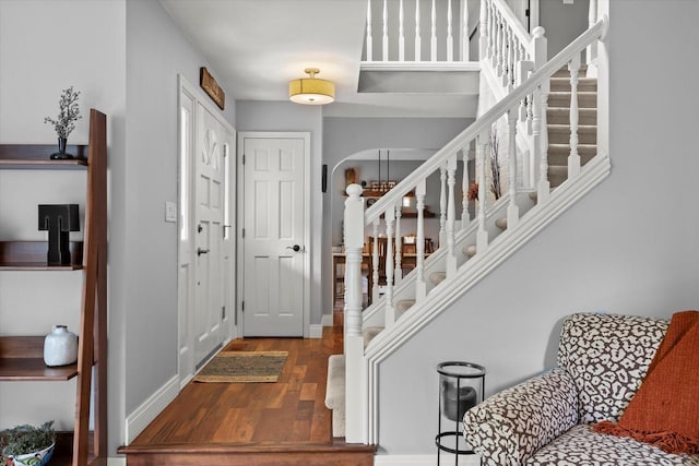 N80W32229 Northbrook Ct, Hartland, WI 53029 - entrance foyer with arched walkways, wood finished floors, and stairs