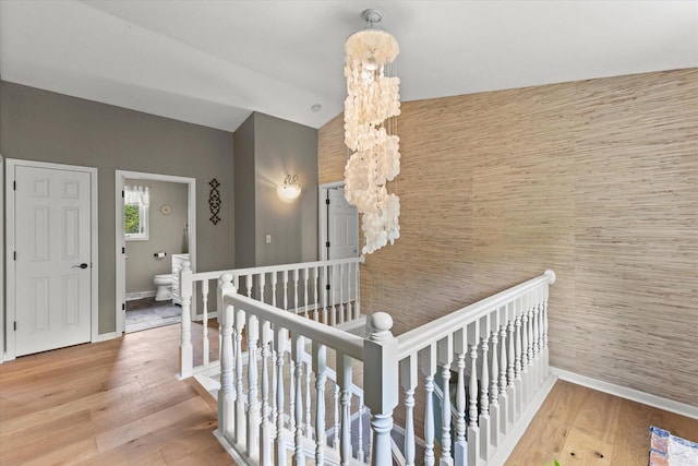 N80W32229 Northbrook Ct, Hartland, WI 53029 - stairs with wood finished floors, lofted ceiling, and a chandelier
