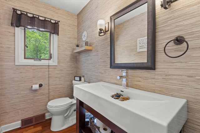 N80W32229 Northbrook Ct, Hartland, WI 53029 - half bath featuring tile walls, vanity, and wood finished floors
