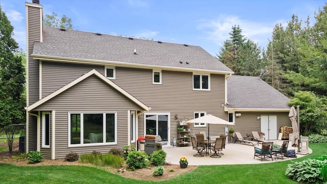N80W32229 Northbrook Ct, Hartland, WI 53029 - back of house with a chimney, a shingled roof, and a patio