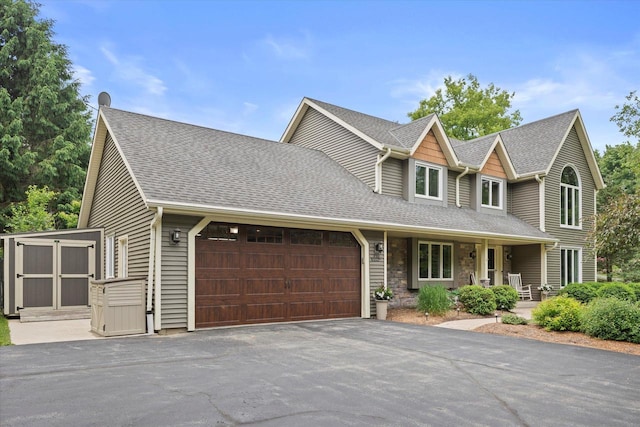 N80W32229 Northbrook Ct, Hartland, WI 53029 - view of front of property featuring an attached garage, covered porch, driveway, and a shingled roof
