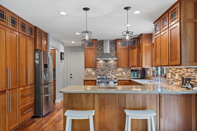 N80W32229 Northbrook Ct, Hartland, WI 53029 - kitchen with wall chimney range hood, stainless steel refrigerator with ice dispenser, stove, a peninsula, and brown cabinetry