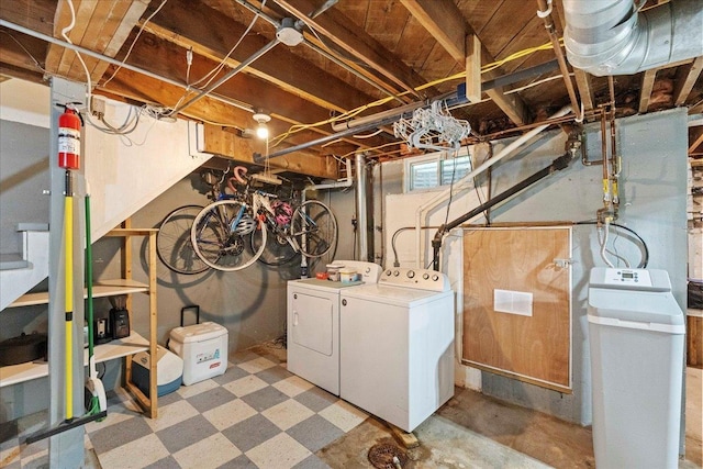 4705 Gordon Ave, Monona, WI 53716 - below grade area featuring washing machine and clothes dryer, a water softener system, and tile patterned floors